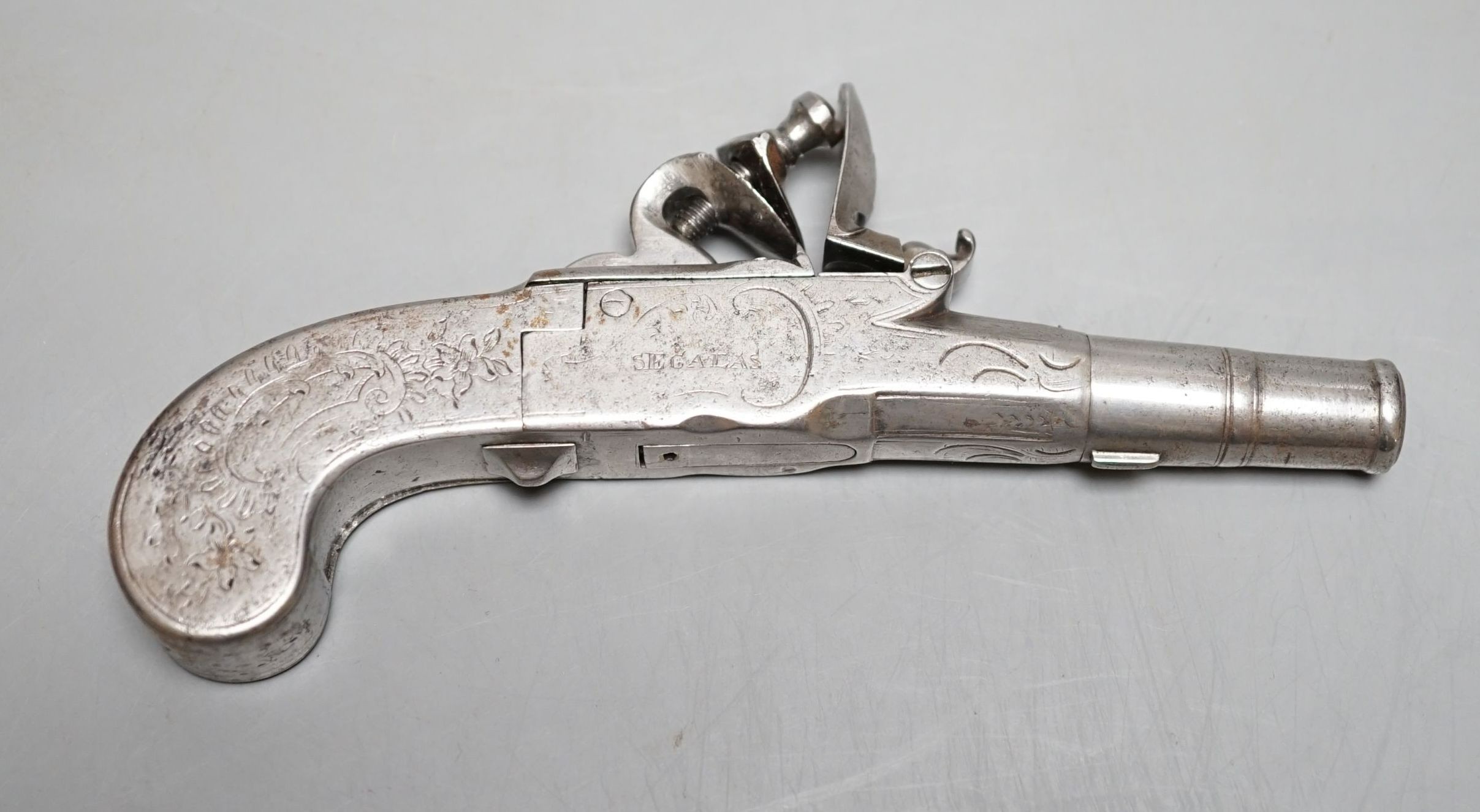 An 18th century steel flintlock pistol, maker London Segalas, 15 cms long.